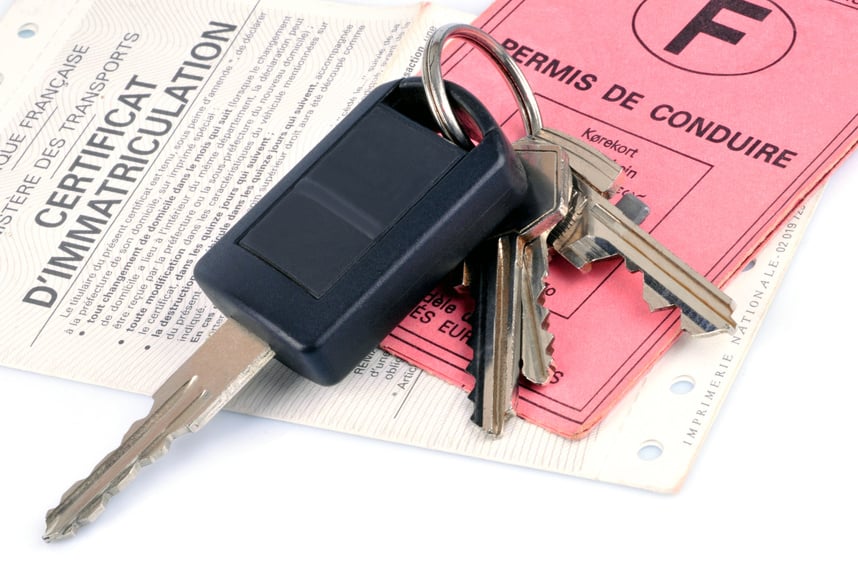 Car key on a driver's license and registration certificate